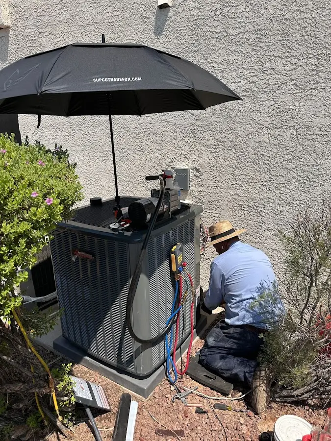 HVAC technician performing outdoor AC maintenance in North Chicago